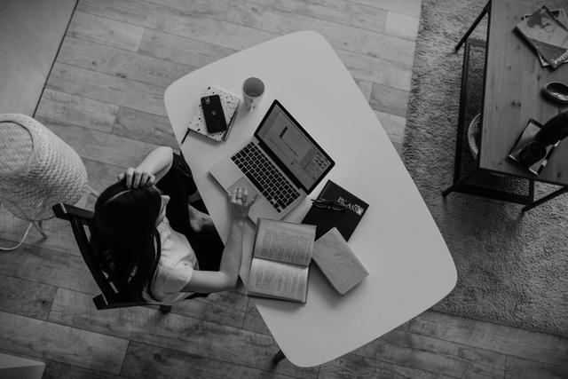 desk with laptop and notes from top